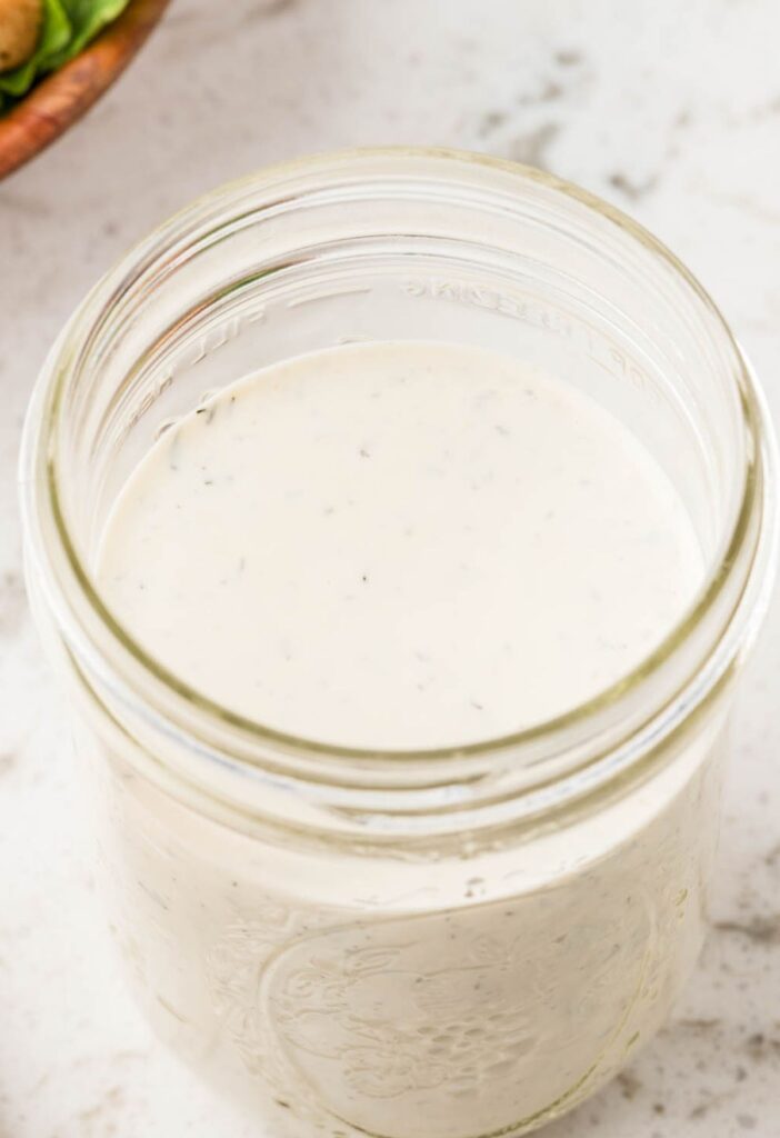 Top view of the glass mason jars with ranch inside of it