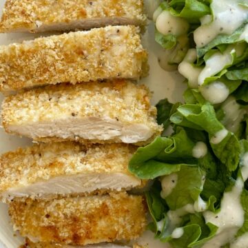 Baked Caesar Chicken with a crispy coating of breadcrumbs, croutons, and dipped in Caesar dressing. The coating stays on this crispy baked chicken so well thanks to the egg!