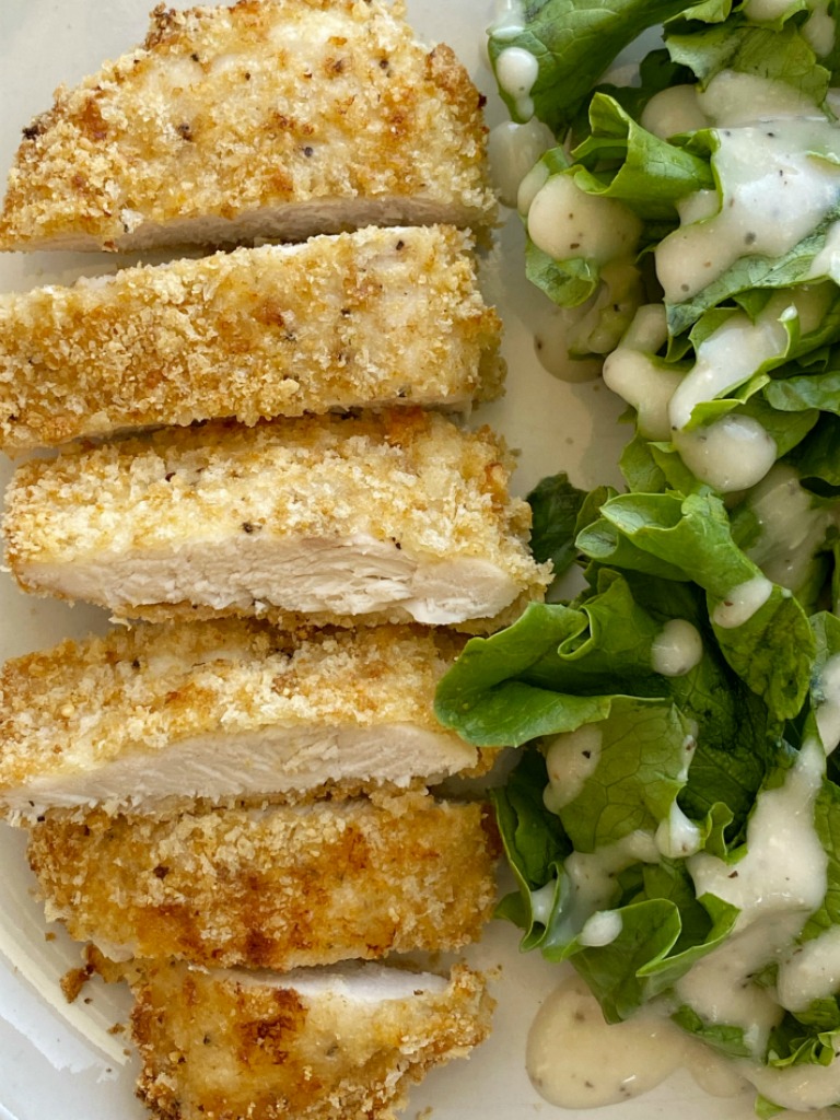 Baked Caesar Chicken with a crispy coating of breadcrumbs, croutons, and dipped in Caesar dressing. The coating stays on this crispy baked chicken so well thanks to the egg!