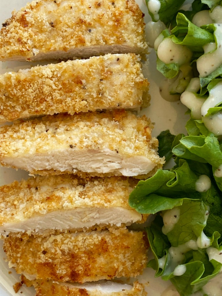 Baked Caesar Chicken with a crispy coating of breadcrumbs, croutons, and dipped in Caesar dressing. The coating stays on this crispy baked chicken so well thanks to the egg!