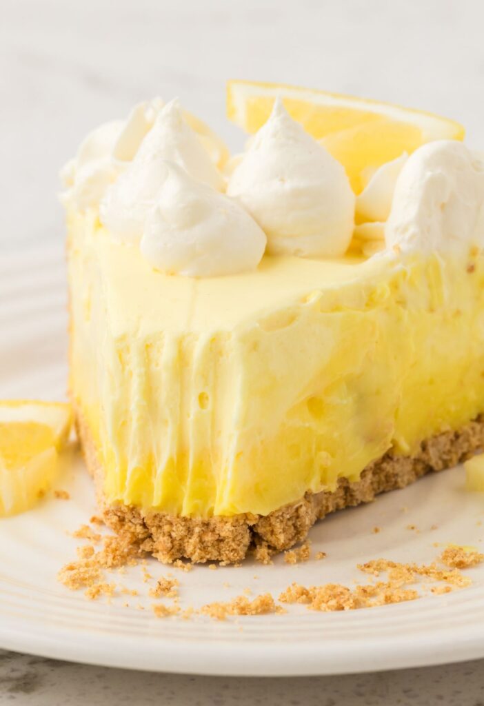 One slice of cheesecake pie with the front with a bite taken out of it with a fork.