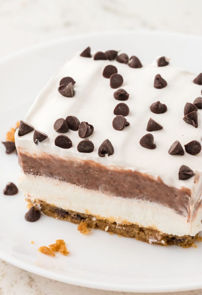 A slice of the layered pudding dessert on a white plate.