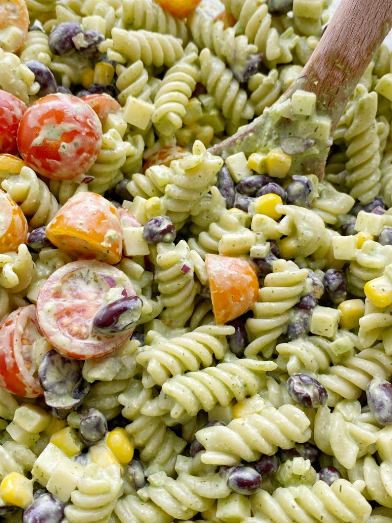 Pasta Salads | Pasta Salad Recipe | Cafe Rio Dressing Pasta Salad | Creamy Cilantro Ranch Pasta Salad is filled with spiral pasta noodles, black beans, corn, red onion, cherry tomatoes, and cubes of cheese with a super creamy (and yummy!) homemade cilantro ranch dressing. #pastasalads #ranch #saladrecipes 