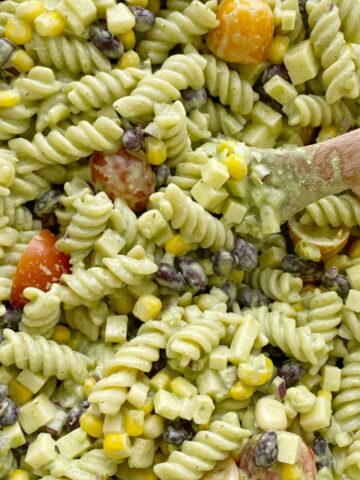 Pasta Salads | Pasta Salad Recipe | Cafe Rio Dressing Pasta Salad | Creamy Cilantro Ranch Pasta Salad is filled with spiral pasta noodles, black beans, corn, red onion, cherry tomatoes, and cubes of cheese with a super creamy (and yummy!) homemade cilantro ranch dressing. #pastasalads #ranch #saladrecipes