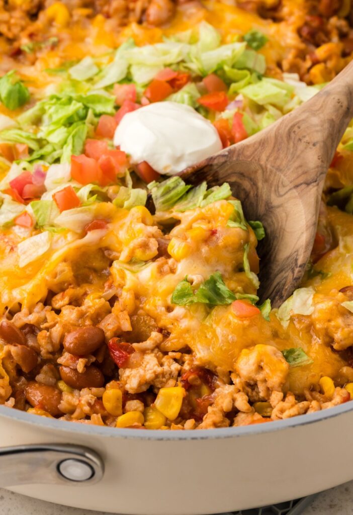 A serving spoon inside the skillet pan
