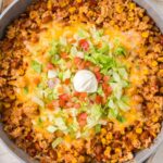 Top view of a skillet pan with ground turkey rice in it.