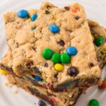 Top view of a stack of cookie bars with a bite taken out of the top bar.