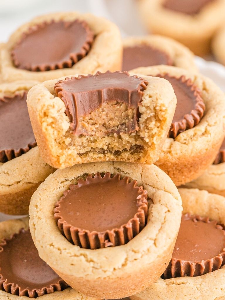 Stack of cookie cups with peanut butter reeses in the middle.