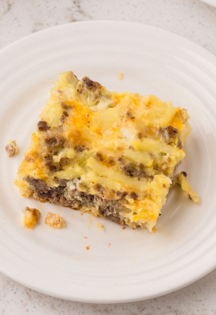 A piece of breakfast casserole on a white plate. 
