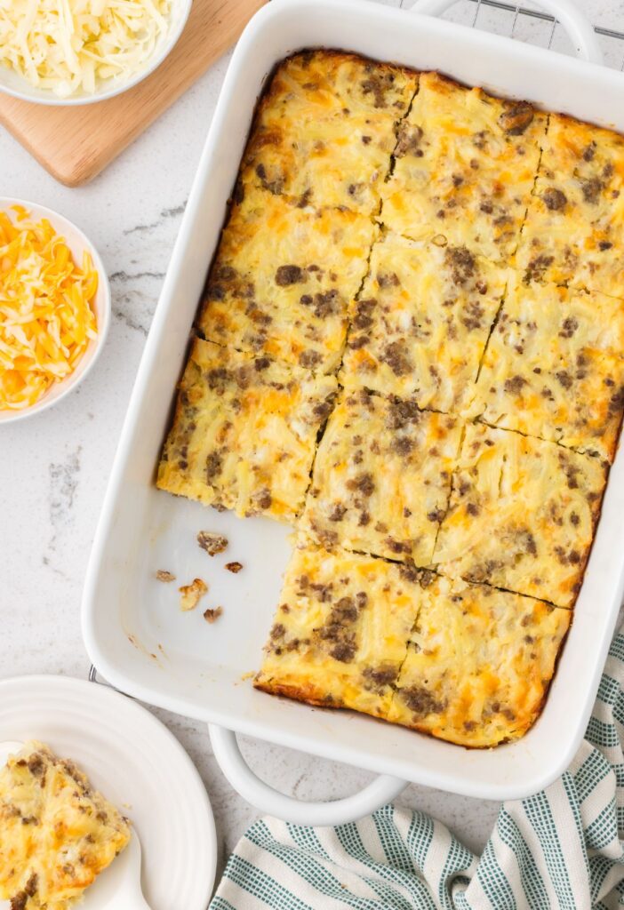 A pan of the breakfast casserole with a piece taken out of it