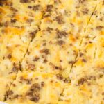 A white casserole dish with a breakfast casserole inside.