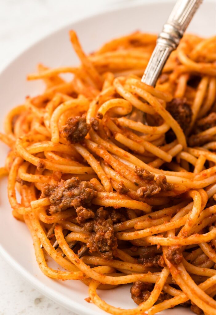 A fork twirling some pasta on it