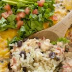 Chicken Enchilada Rice Casserole is a layered dinner with rice, black beans, and a creamy chicken mixture with olives, tomatoes, sour cream, and green enchilada sauce. Topped with cheese for the ultimate chicken enchilada casserole.