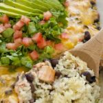 Chicken Enchilada Rice Casserole is a layered dinner with rice, black beans, and a creamy chicken mixture with olives, tomatoes, sour cream, and green enchilada sauce. Topped with cheese for the ultimate chicken enchilada casserole.