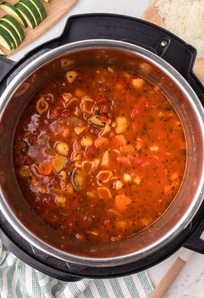 Insert of the instant pot with cooked minestrone soup inside of it.