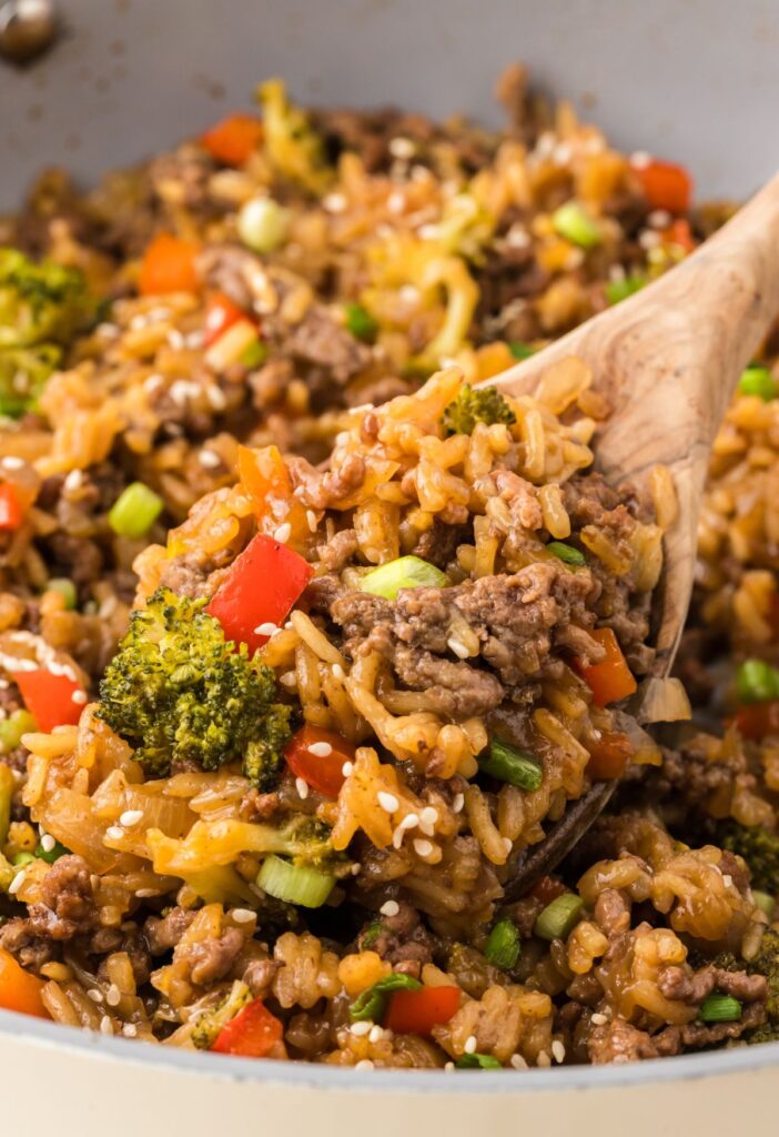 A skillet pan with a wooden spoon