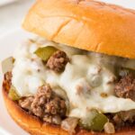 A sloppy Joe with meat filling and melted cheese.