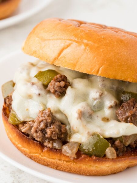 A sloppy Joe with meat filling and melted cheese.