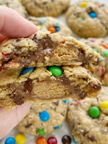 Reese's Stuffed Monster Cookies are monster cookies loaded with oats, peanut butter, chocolate chips, m&m's and stuffed with a Reese's miniature in the center! So soft, thick, chewy, and just the best cookie ever.