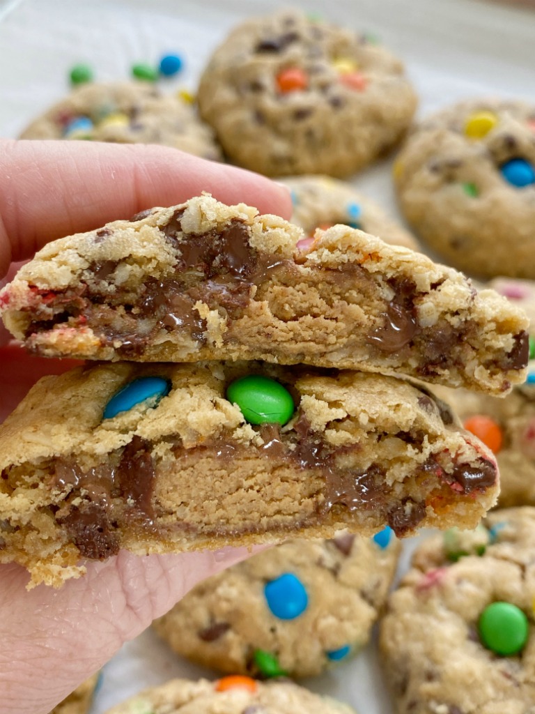 Reese's Stuffed Monster Cookies are monster cookies loaded with oats, peanut butter, chocolate chips, m&m's and stuffed with a Reese's miniature in the center! So soft, thick, chewy, and just the best cookie ever. 