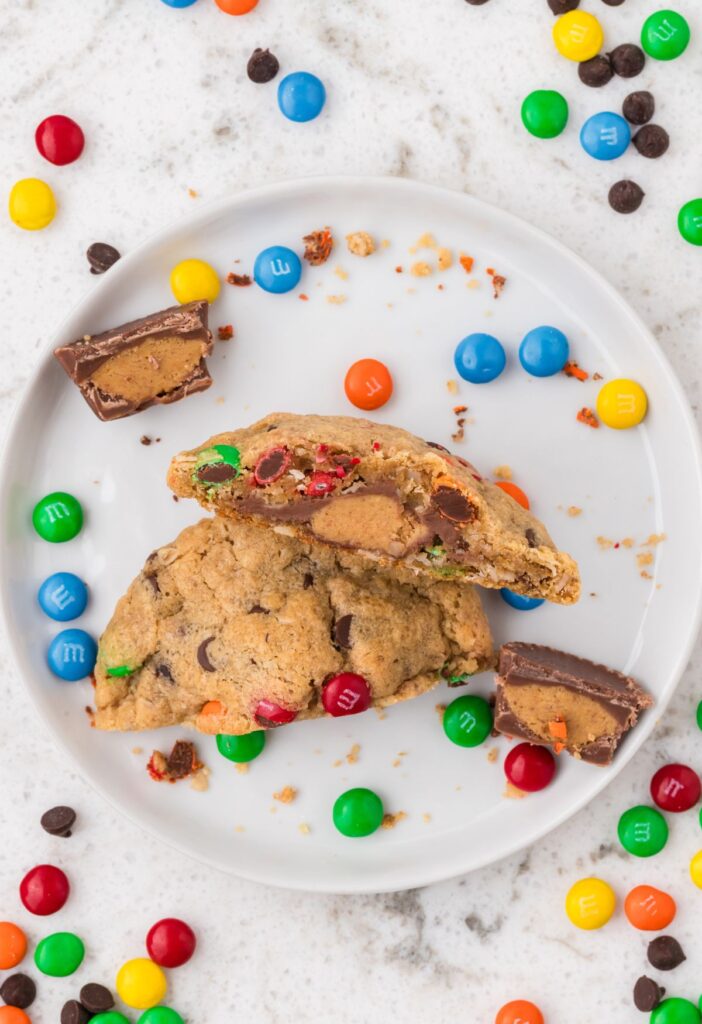 hero shot of a cookie cut in half so you can see the Reeses peanut butter cup in the center of the monster cookie. 