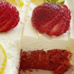 Strawberry Lemonade Cake starts with a lemon cake mix + strawberry pie filling! So easy to make, crazy moist, and topped with the fluffiest & lightest whipped pudding frosting.