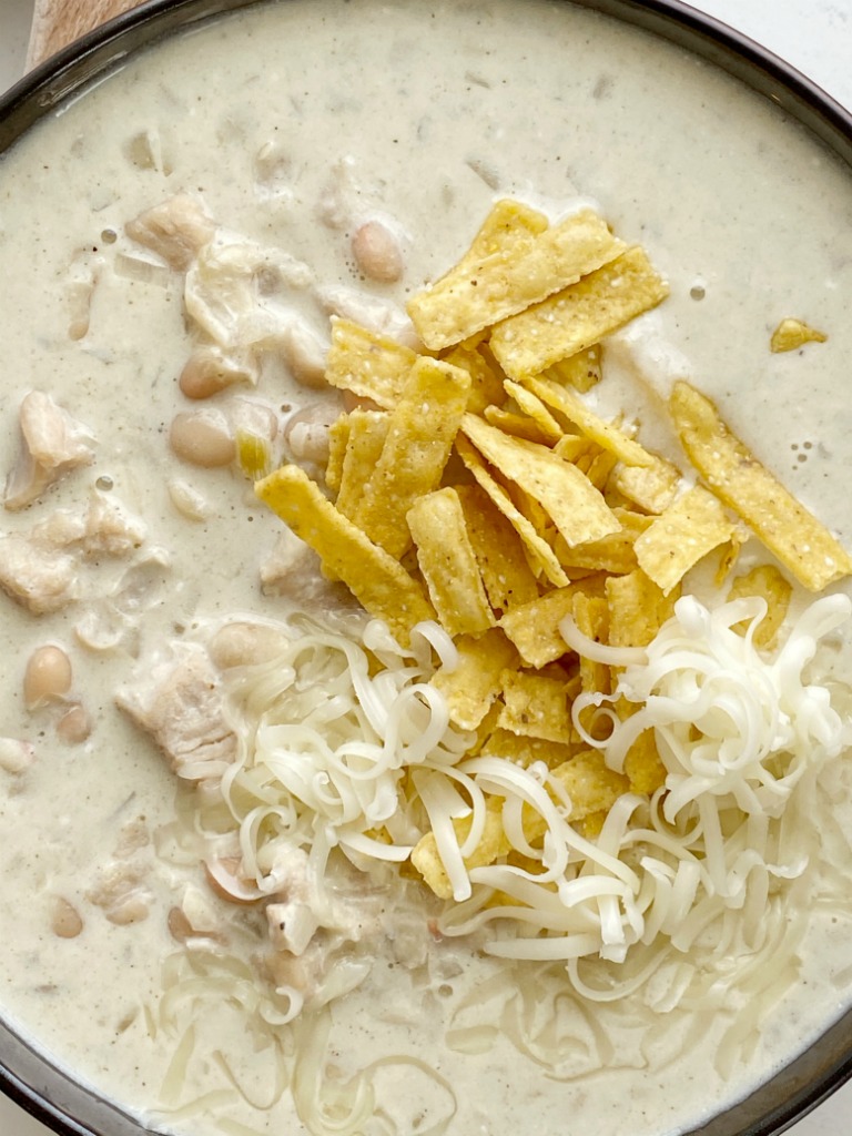 White Chicken Chili is a creamy white chili that's made in just one pot! Chunks of chicken and white beans in a chicken broth green chili base and sour cream and heavy cream to make it super creamy.