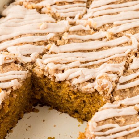 A pan of the cake with a piece taken out of it.