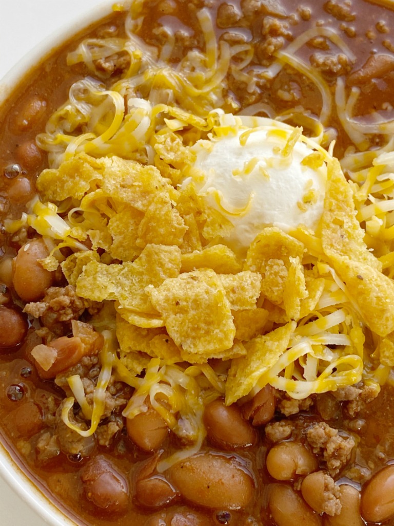 Crockpot Chili is sweet & spicy and so good served with sour cream, cheese, and Fritos. Made with three different beans, ground beef, tomato sauce, beef broth, seasonings, and my favorite chili ingredient ... cocoa powder! 