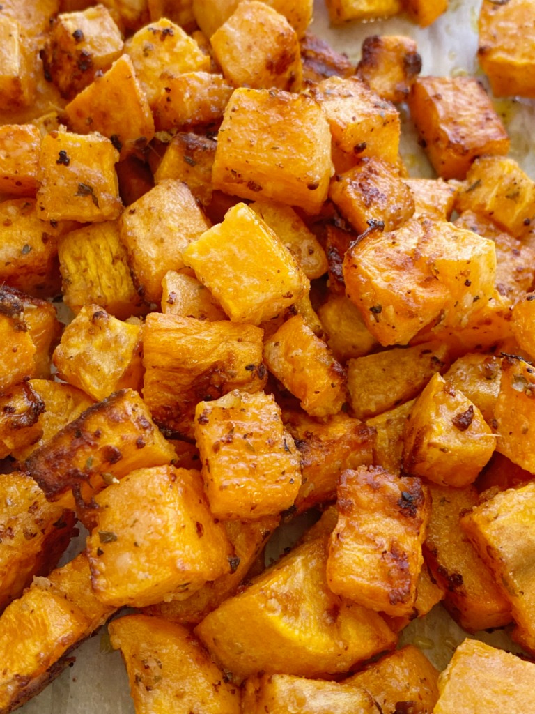 Roasted Garlic Parmesan Sweet Potatoes are roasted in butter, olive oil, parmesan cheese, and seasonings. A crispy charred outside with a soft sweet potato center. One bowl and a few simple ingredients are all you need for this delicious side dish recipe.