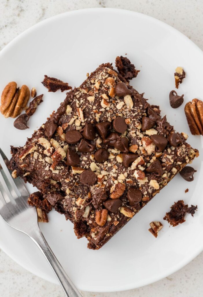 Overhead pic of a piece of the dump cake on a white plate with a fork. 