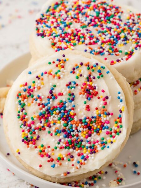 Stack of cookies with one sugar cookie leaning up against it