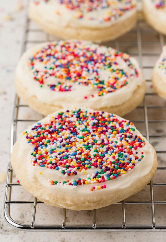 Side view of a cookie with frosting on the cooling rack