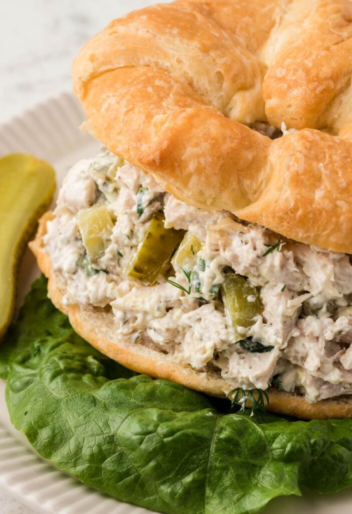A croissant with the chicken salad inside of it
