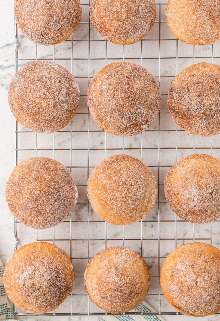 Top view of the baked donut muffins on a cooling rack.