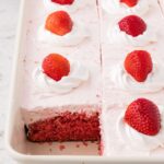 Side view of the cake pan with the cake inside and a piece taken out of it.