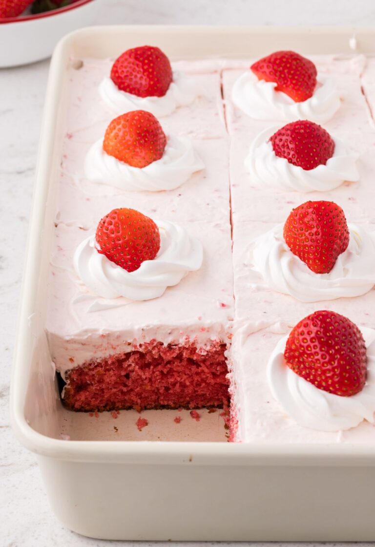 Side view of the cake pan with the cake inside and a piece taken out of it.