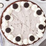 A pudding pie cut into slices with Oreo cookies on top.