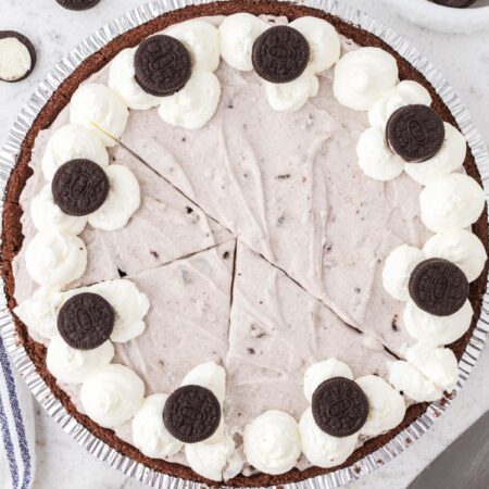 A pudding pie cut into slices with Oreo cookies on top.