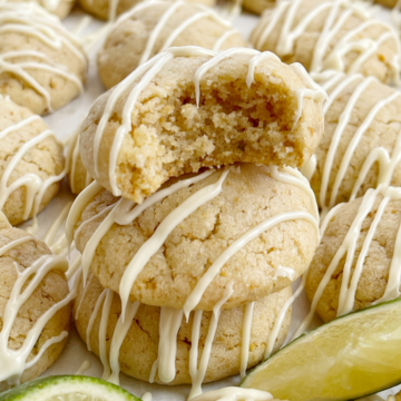 Stack of key lime pie cookies with a lime wedge.