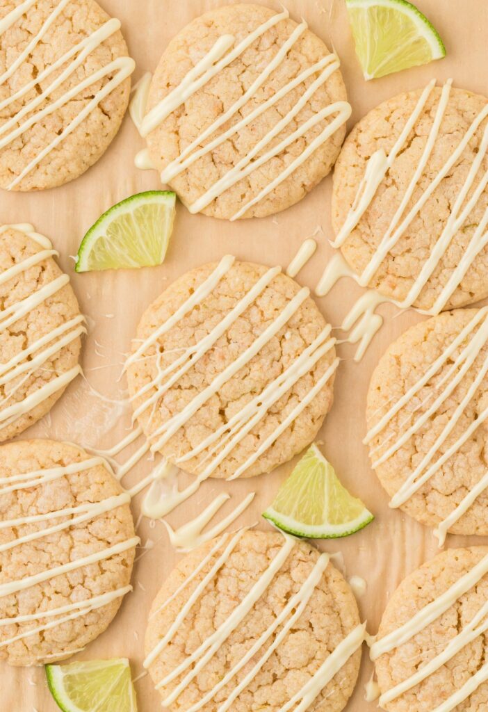 Baking sheet with the cookies on it and lime wedges.