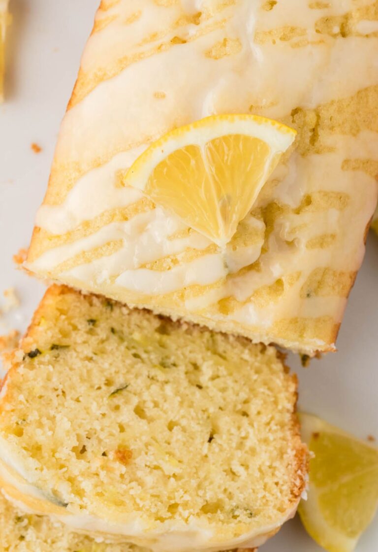 Top view of lemon bread with glaze and lemon slice.