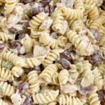 A close up picture of poppy seed chicken pasta salad with grapes in it.