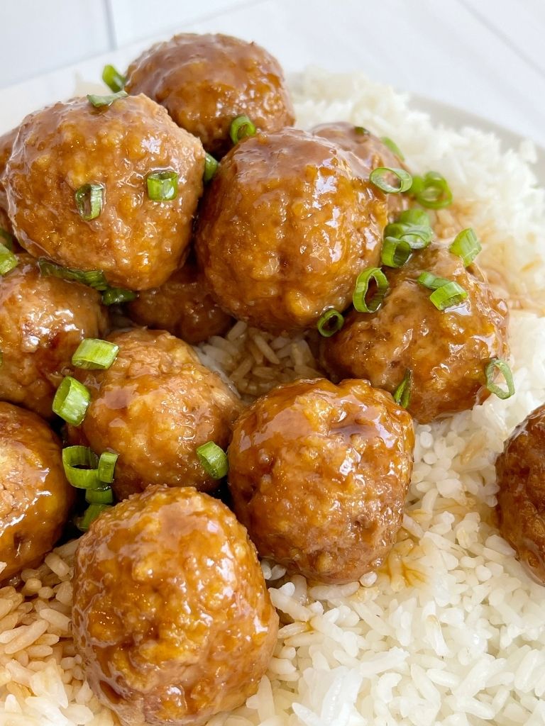 Turkey meatballs on top of rice on a white plate.