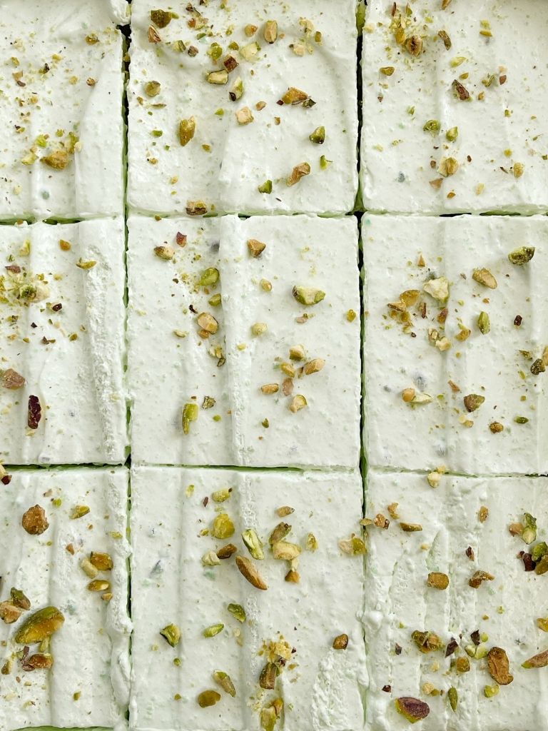 Overhead shot of pistachio cake with frosting.