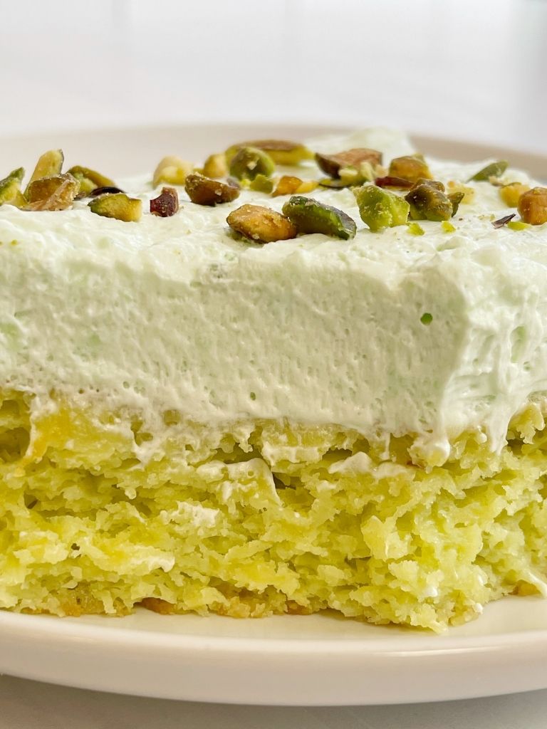 Slice of pistachio with a bite taken out of it.