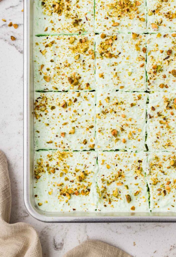Top view of the cake pan with the frosted cake inside of it, uncut.