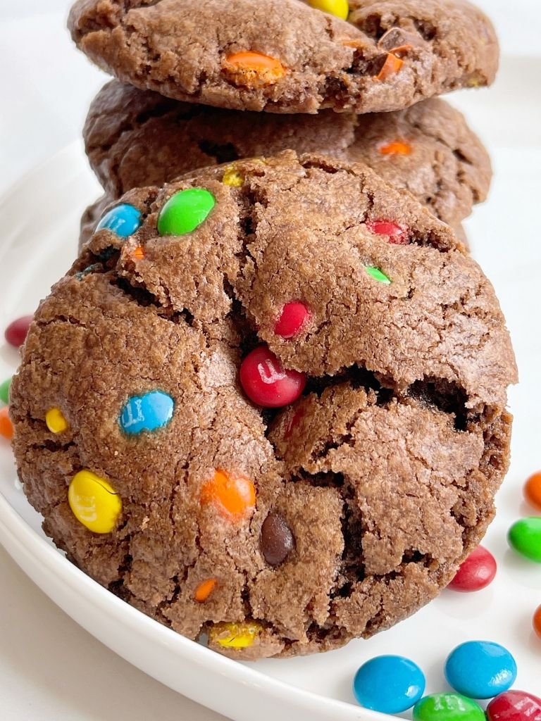 Close up shot of a chocolate cookie with m&m's on it. 