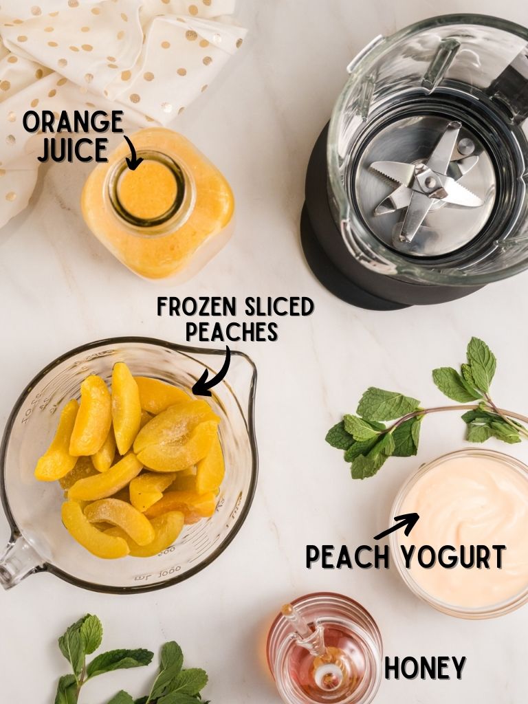 A picture of the ingredients needed to make a peach smoothie with each one labeled in text. 