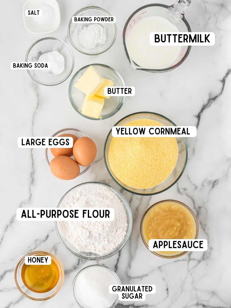 A picture of ingredients needed to make cornbread with each ingredient labeled in text with what it is. 